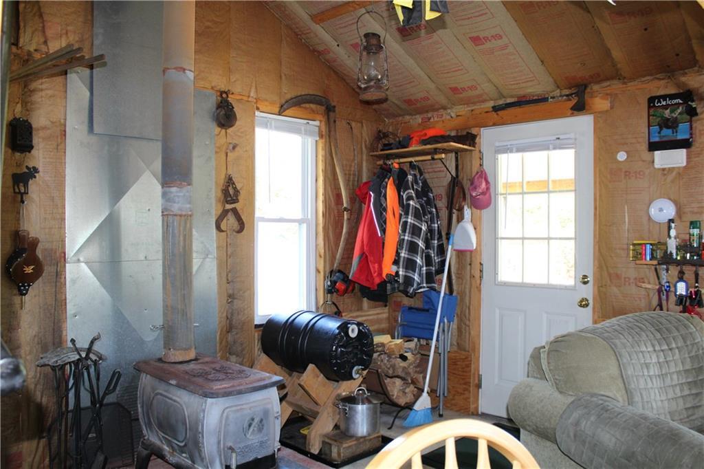 62 Ledge View Road West Forks, ME 04985 - Photo 18 of 33 Entrance door with wood stove and...