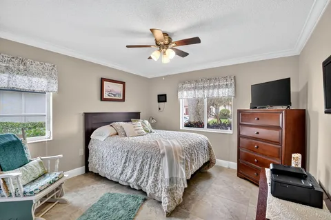 a bedroom with a bed and a television