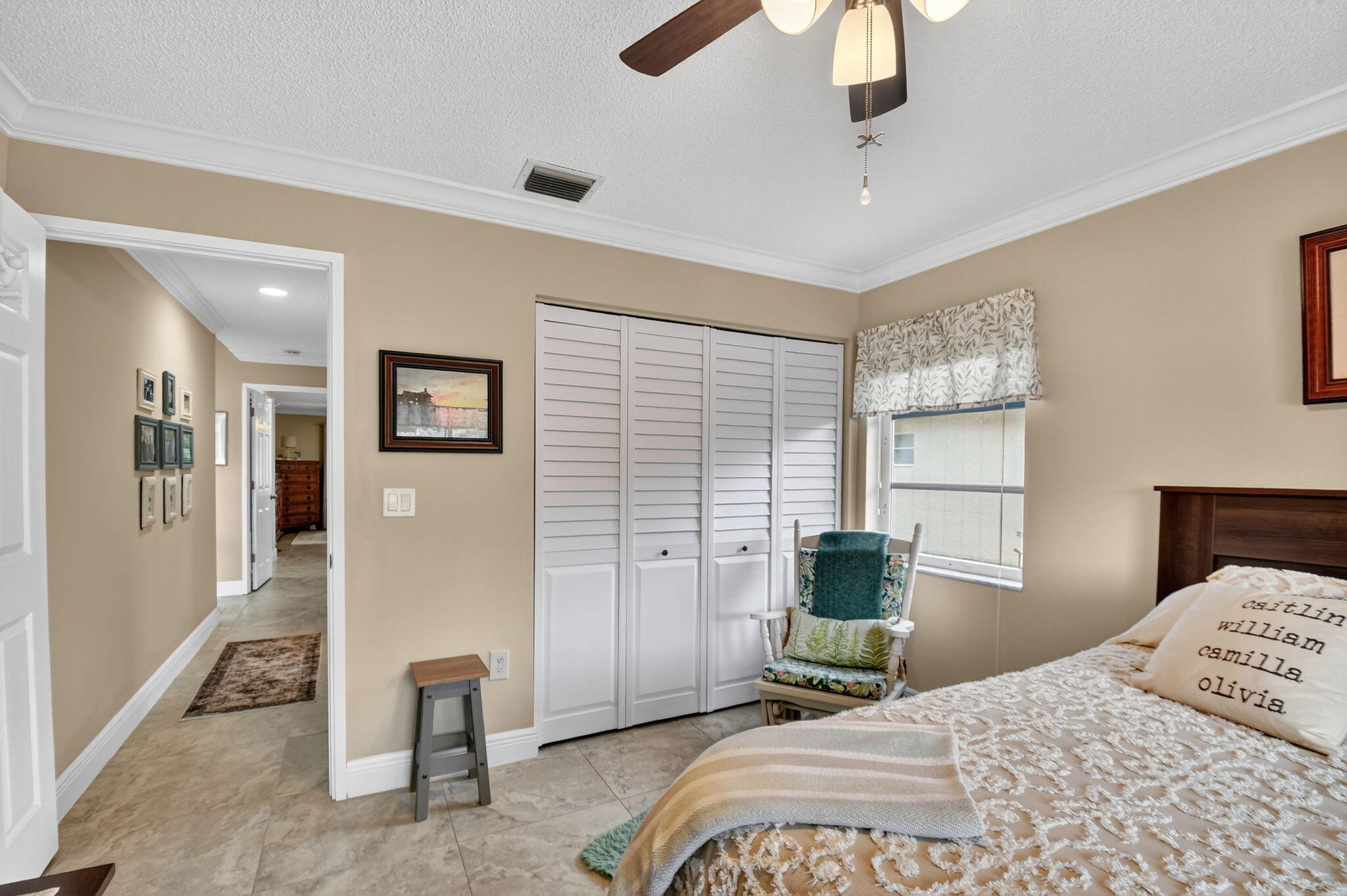 6426 Mill Pointe Circle Delray Beach, FL 33484 - Photo 22 of 57 a bedroom with a bed and a chandelier