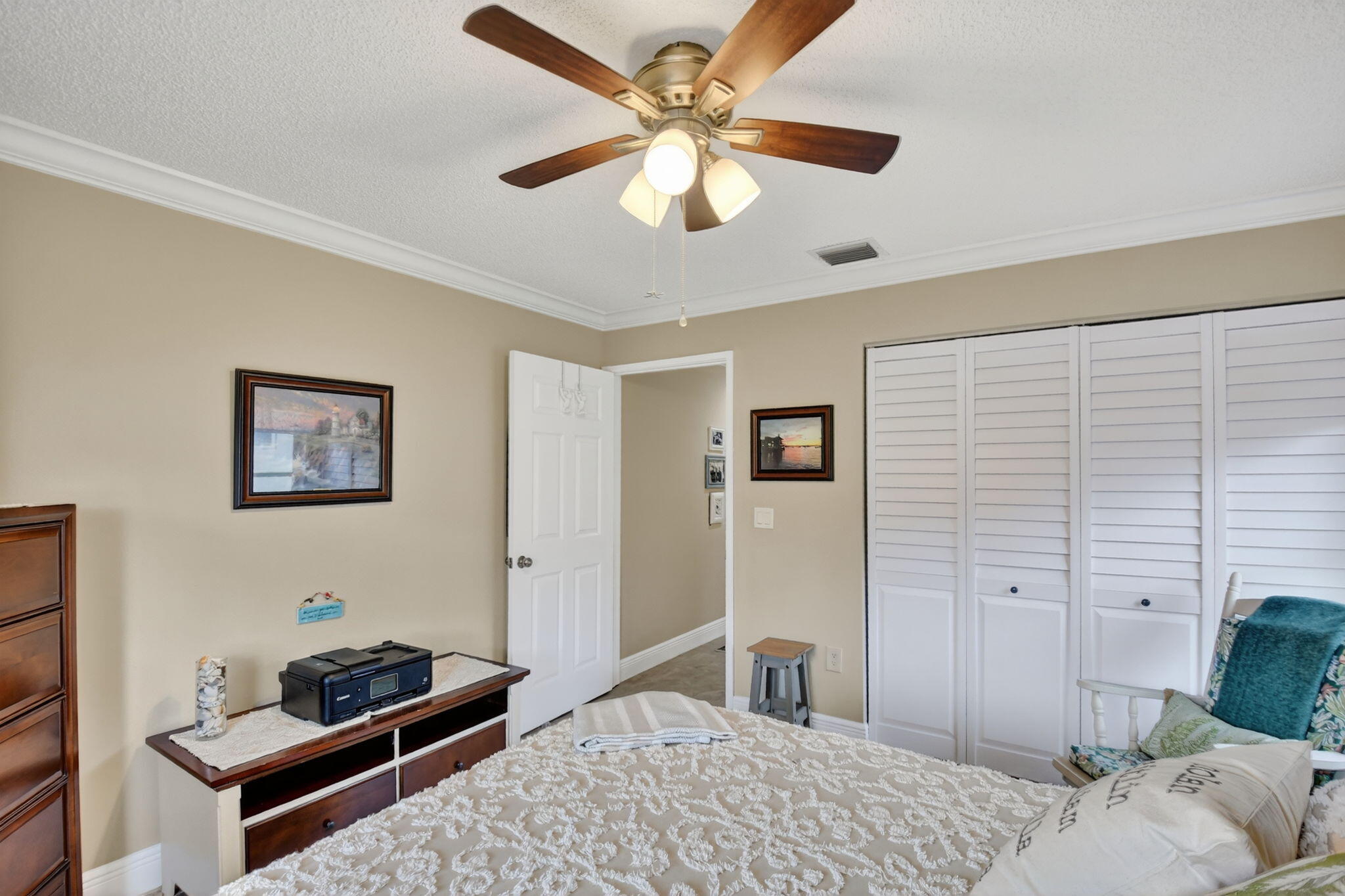 6426 Mill Pointe Circle Delray Beach, FL 33484 - Photo 23 of 57 a bedroom with a bed and a dresser
