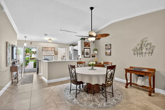 a view of a dining room and livingroom with furniture wooden floor a chandelier