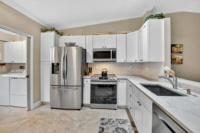 a kitchen with a sink appliances and cabinets