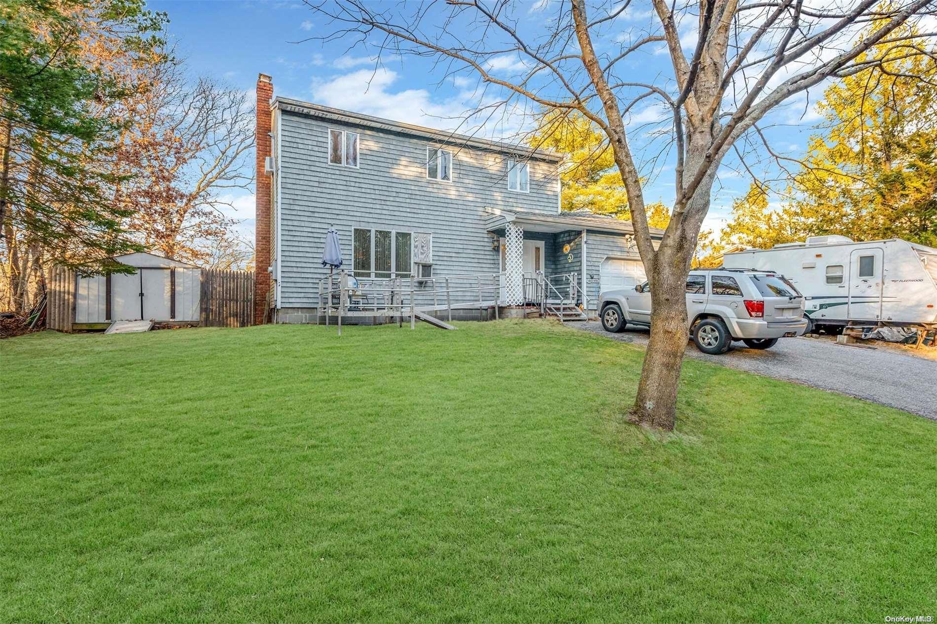 a house that has a tree in front of it