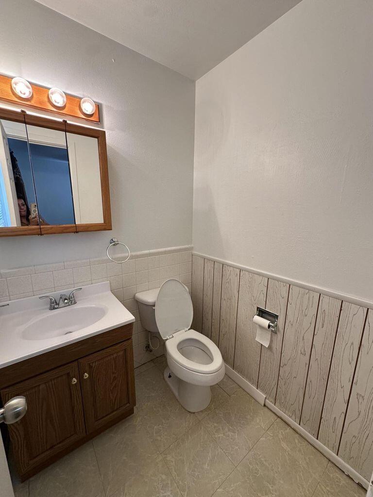2807 Lexington Street Plainview, TX 79072 - Photo 11 of 16 a bathroom with a toilet sink and mirror