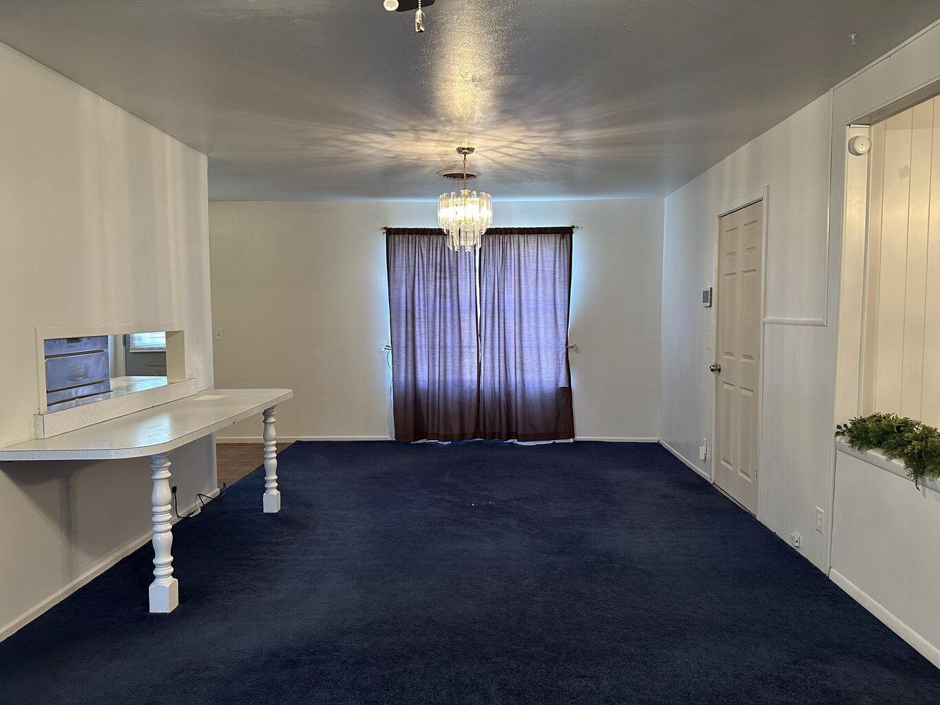 2807 Lexington Street Plainview, TX 79072 - Photo 4 of 16 wooden floor and chandelier in a room