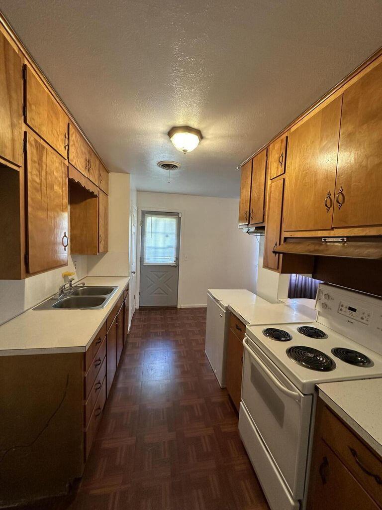 2807 Lexington Street Plainview, TX 79072 - Photo 7 of 16 a kitchen with a stove and a sink