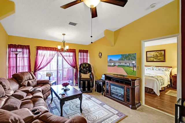 a living room with furniture a air conditioner vent and a window