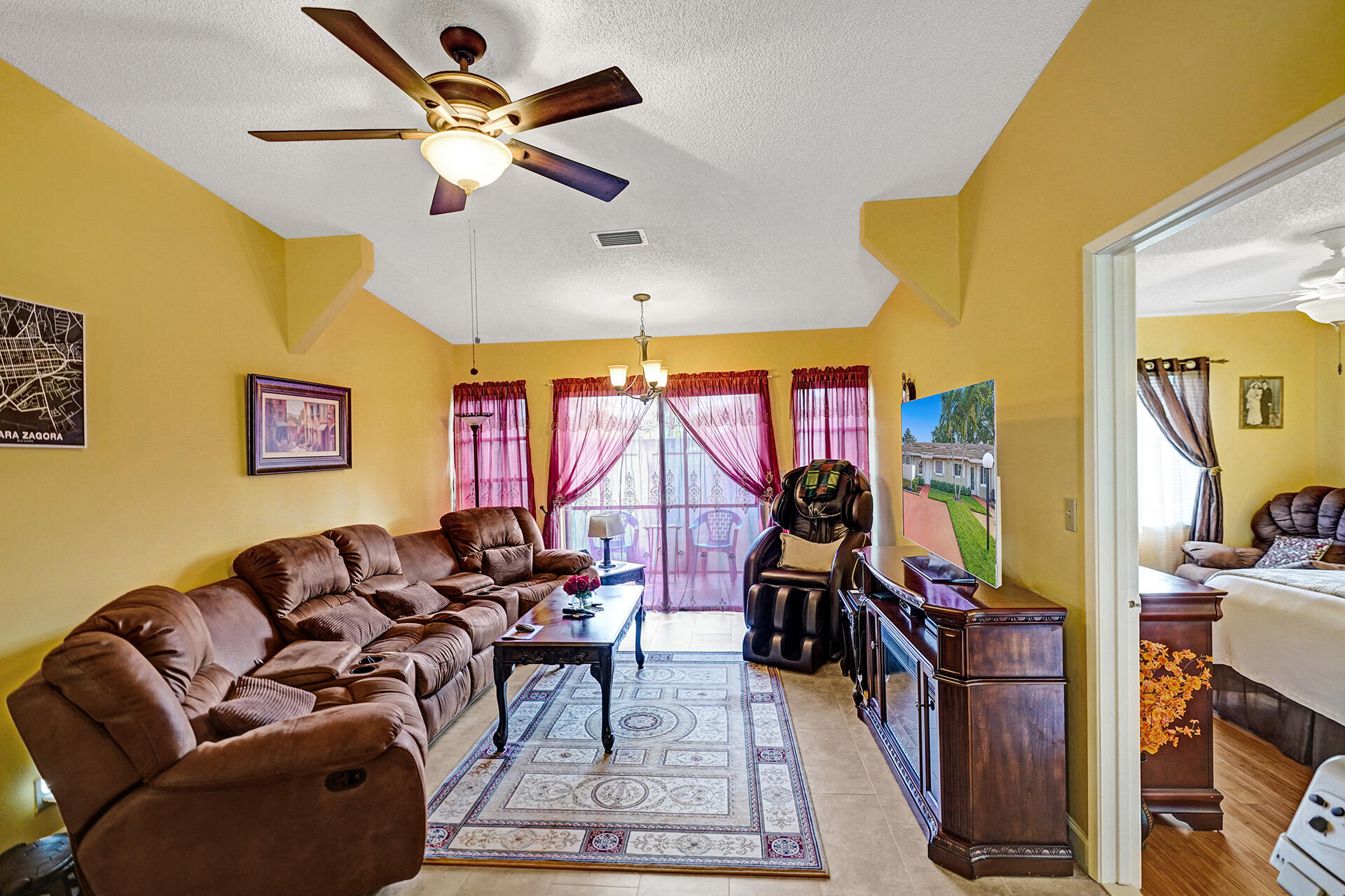 8624 Overset Lane, Unit B Boca Raton, FL 33496 - Photo 12 of 29 a living room with furniture a rug and a chandelier