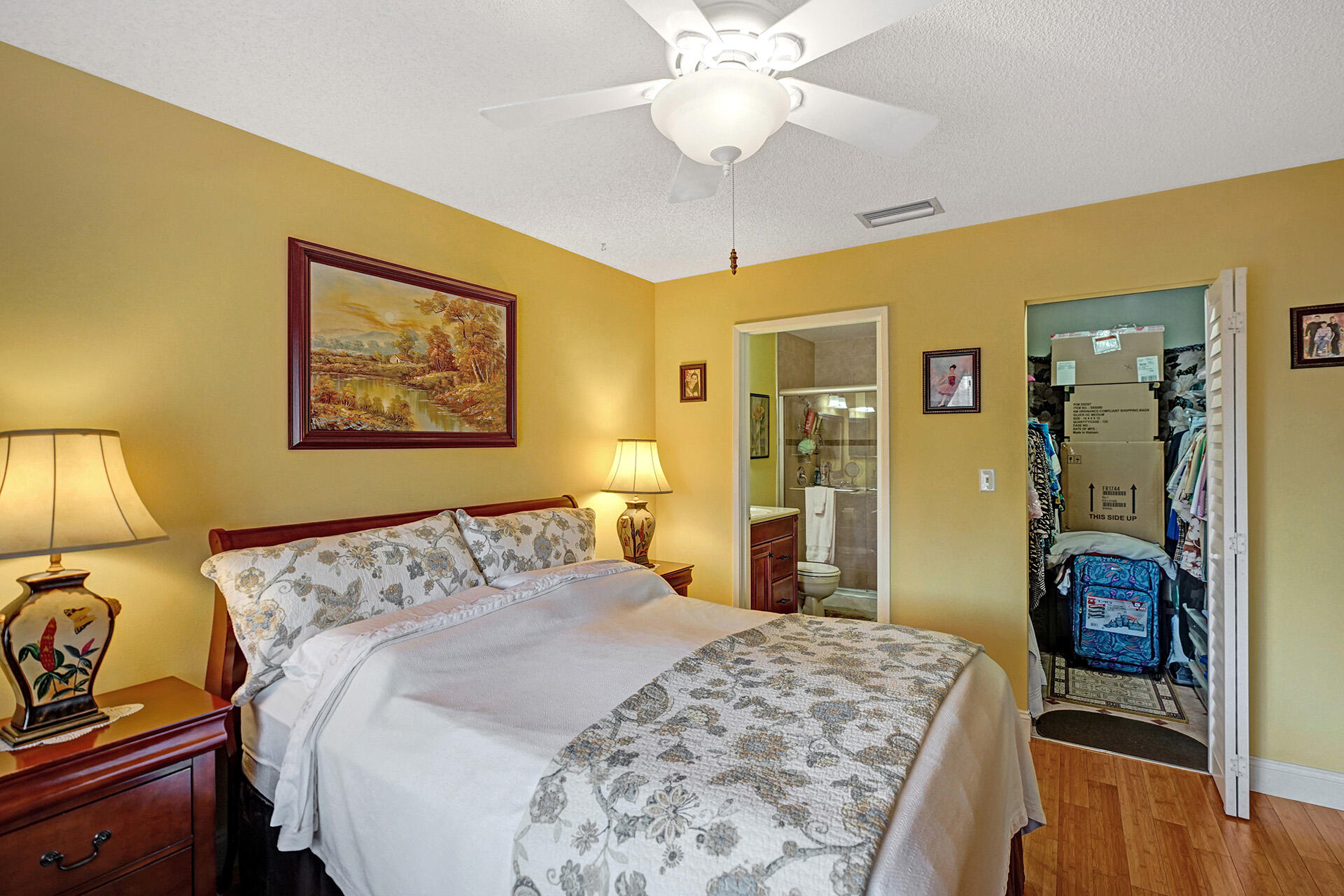 8624 Overset Lane, Unit B Boca Raton, FL 33496 - Photo 2 of 29 a bedroom with a bed and a chandelier