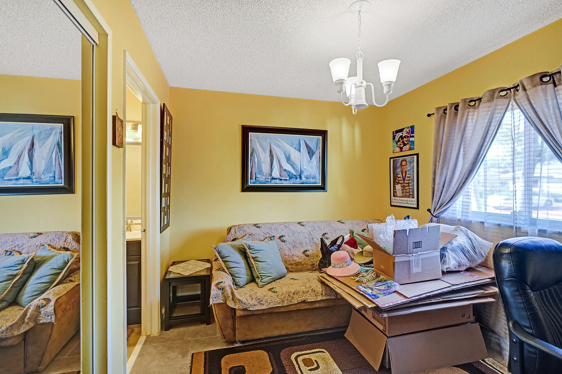 8624 Overset Lane, Unit B Boca Raton, FL 33496 - Photo 21 of 29 a living room with fireplace furniture and a chandelier