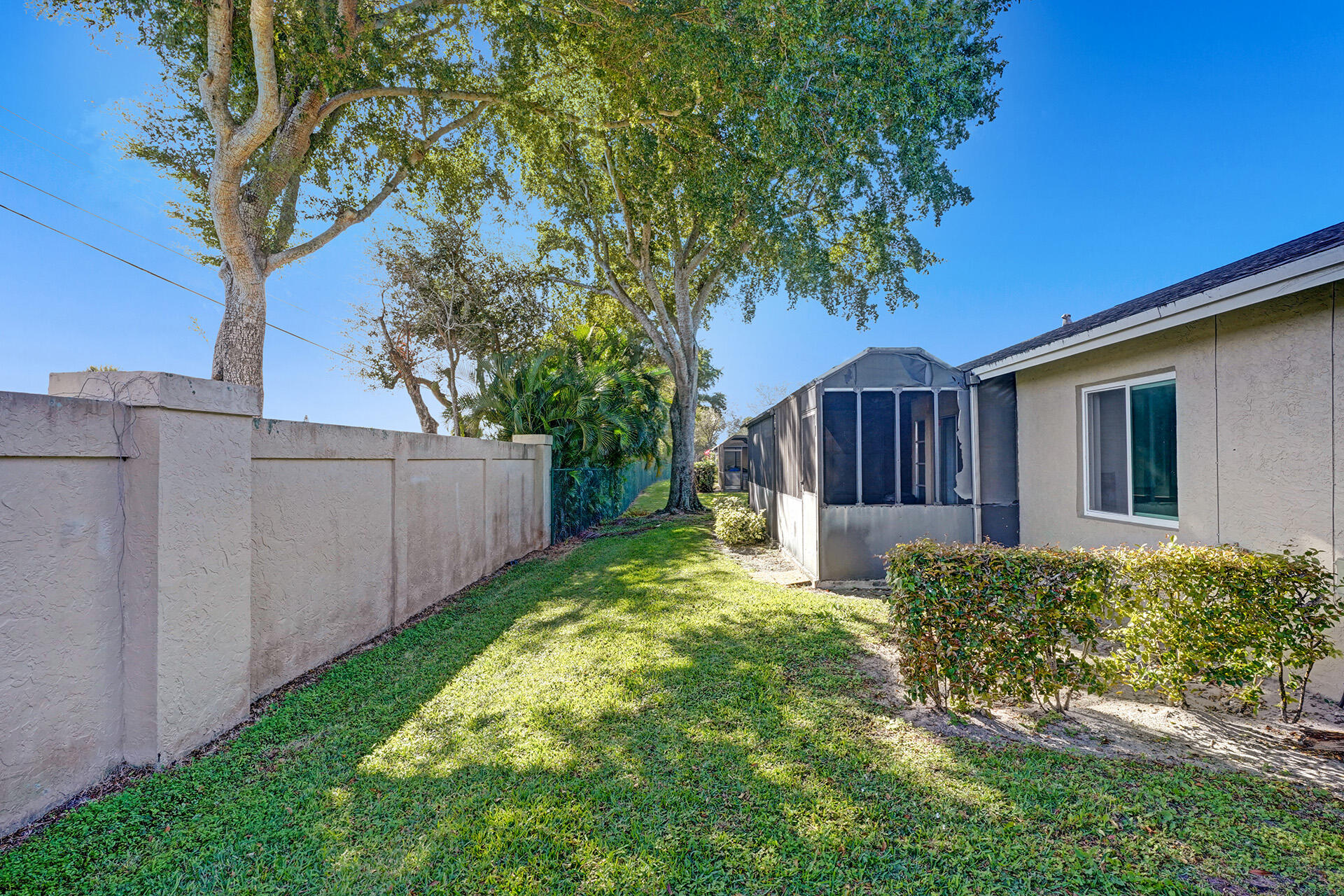 8624 Overset Lane, Unit B Boca Raton, FL 33496 - Photo 27 of 29 a view of a house with a small yard and wooden fence