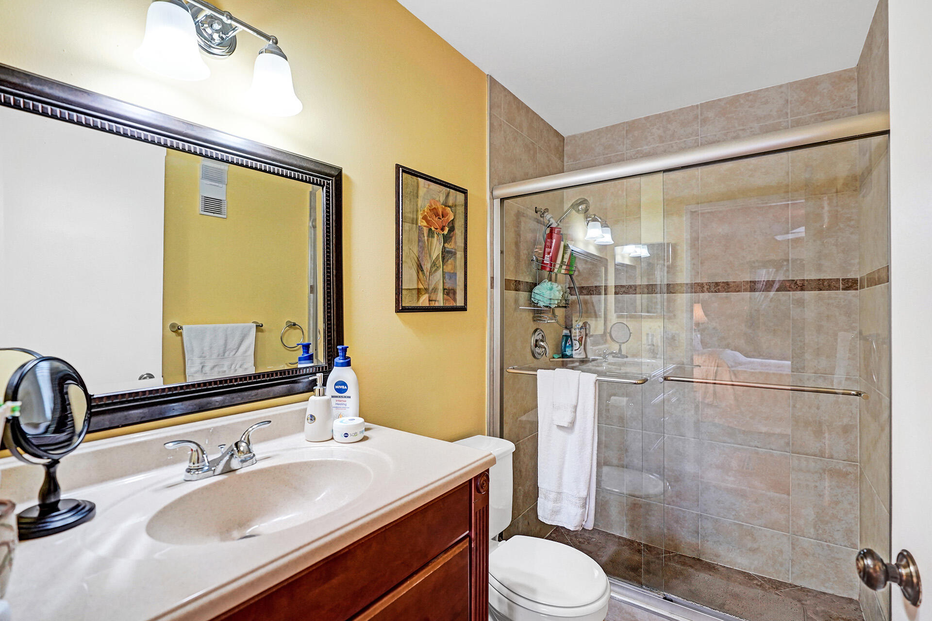 8624 Overset Lane, Unit B Boca Raton, FL 33496 - Photo 4 of 29 a bathroom with a sink mirror toilet and shower