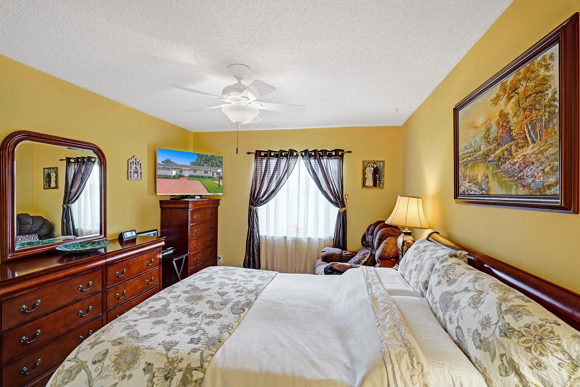 8624 Overset Lane, Unit B Boca Raton, FL 33496 - Photo 5 of 29 a bed room with a bed and a flat tv screen on dresser