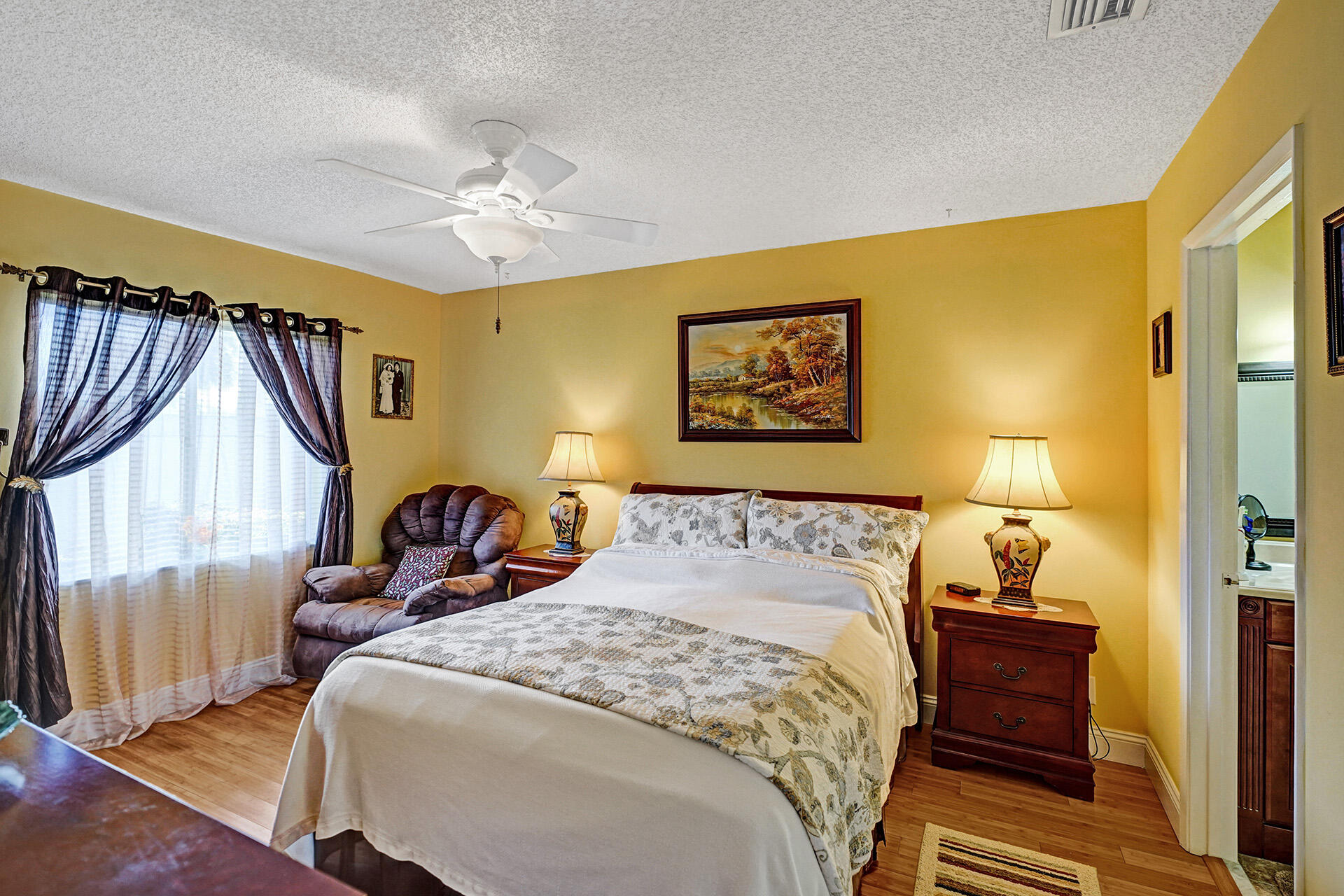 8624 Overset Lane, Unit B Boca Raton, FL 33496 - Photo 6 of 29 a bedroom with a bed and a chandelier