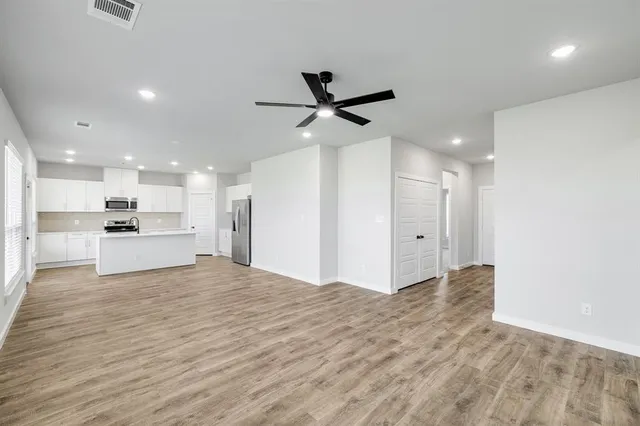 a view of a kitchen with a sink and a refrigerator