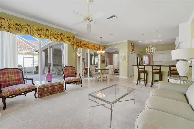 a living room with furniture and a chandelier