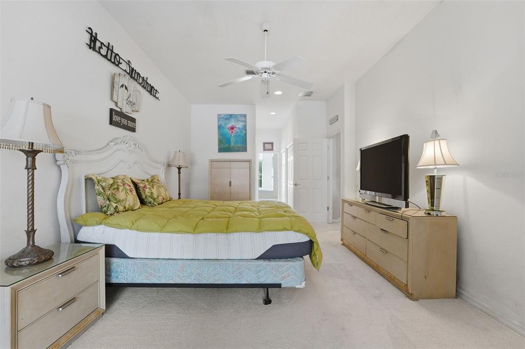 507 Cheval Drive Venice, FL 34292 - Photo 24 of 43 a spacious bedroom with a bed and a flat screen tv
