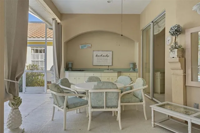 a view of a dining room with furniture and a window