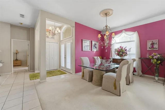 a living room with furniture a chandelier and a chandelier