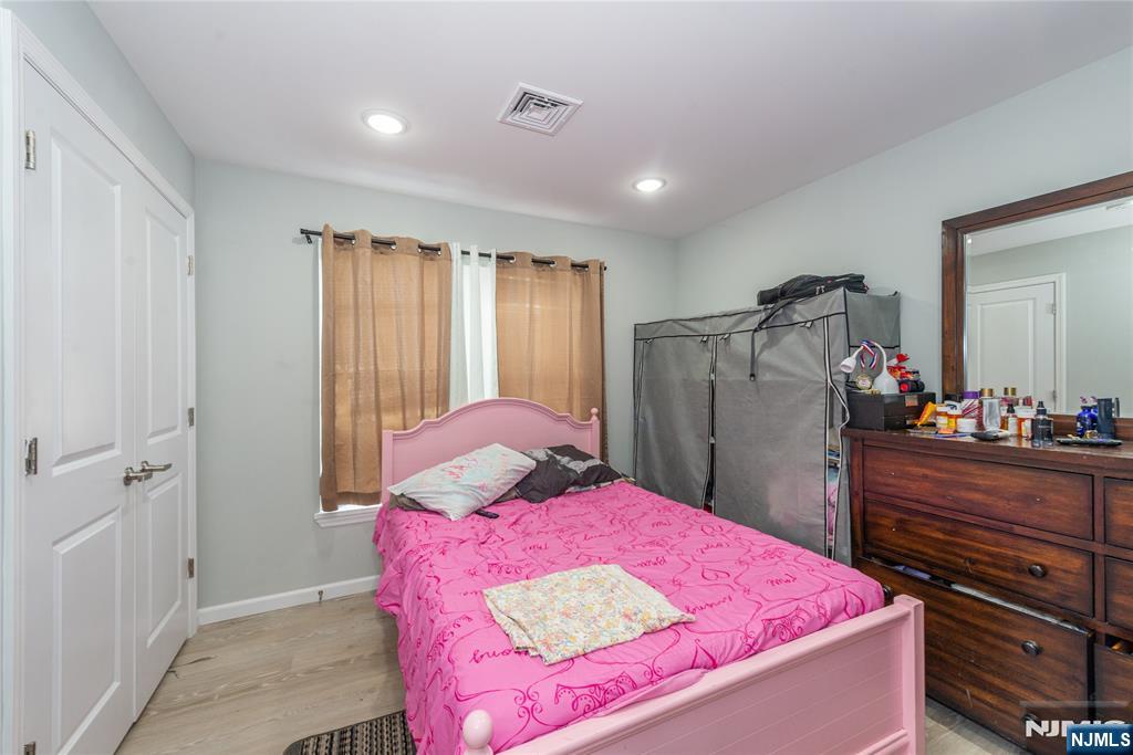 59 Mercer Street Paterson, NJ 07524 - Photo 12 of 15 a bedroom with a bed and a dresser