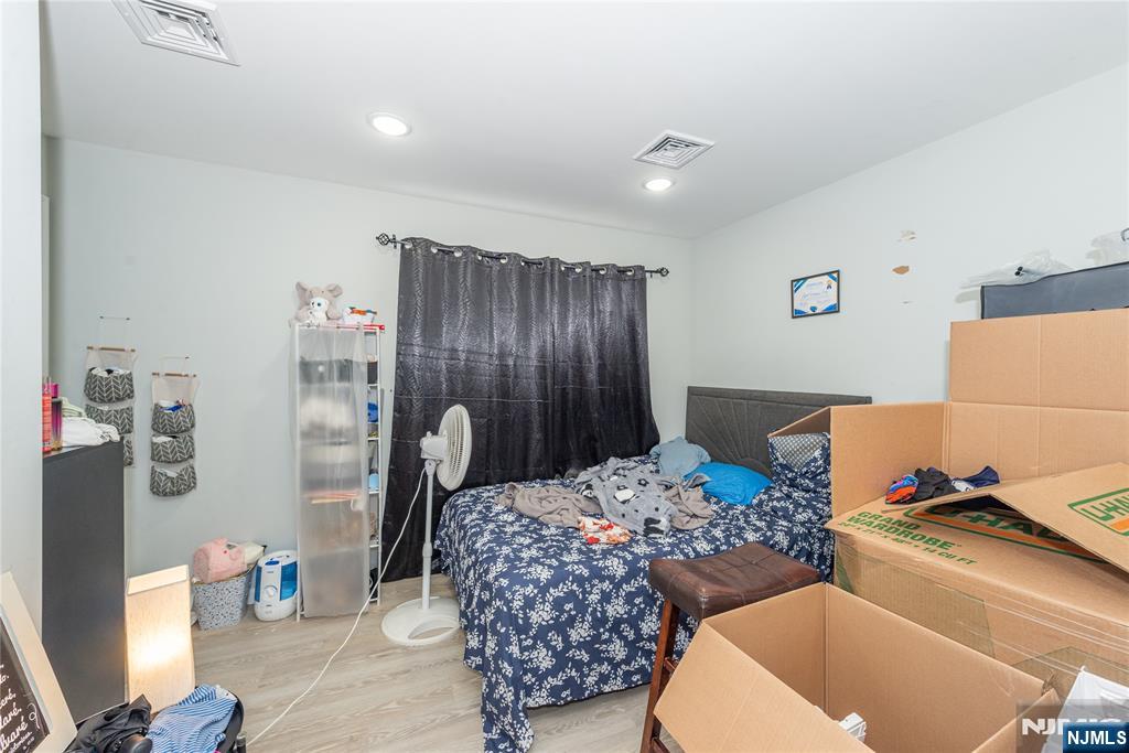 59 Mercer Street Paterson, NJ 07524 - Photo 13 of 15 a bedroom with a bed and a dresser