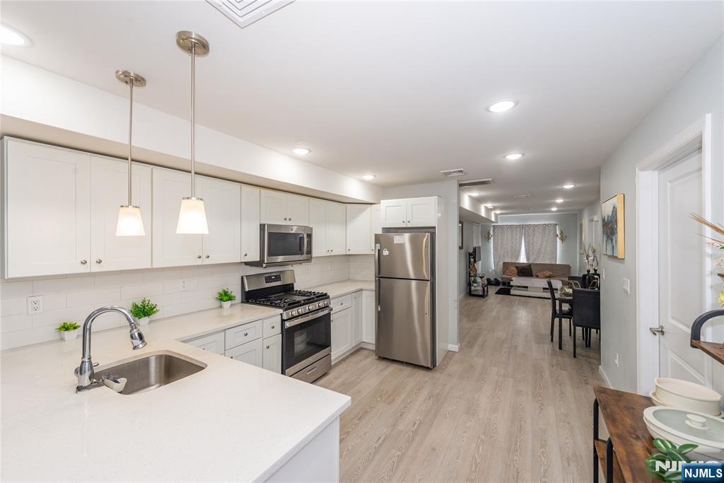 59 Mercer Street Paterson, NJ 07524 - Photo 2 of 15 a kitchen with refrigerator and cabinets
