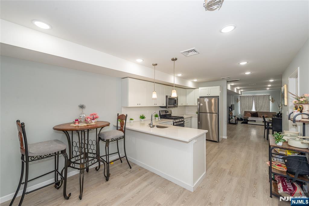 59 Mercer Street Paterson, NJ 07524 - Photo 3 of 15 a kitchen with a table and chairs in it