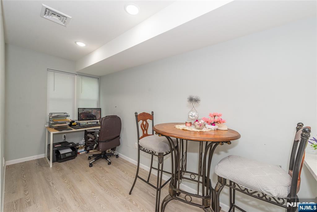59 Mercer Street Paterson, NJ 07524 - Photo 7 of 15 a workspace with furniture and wooden floor