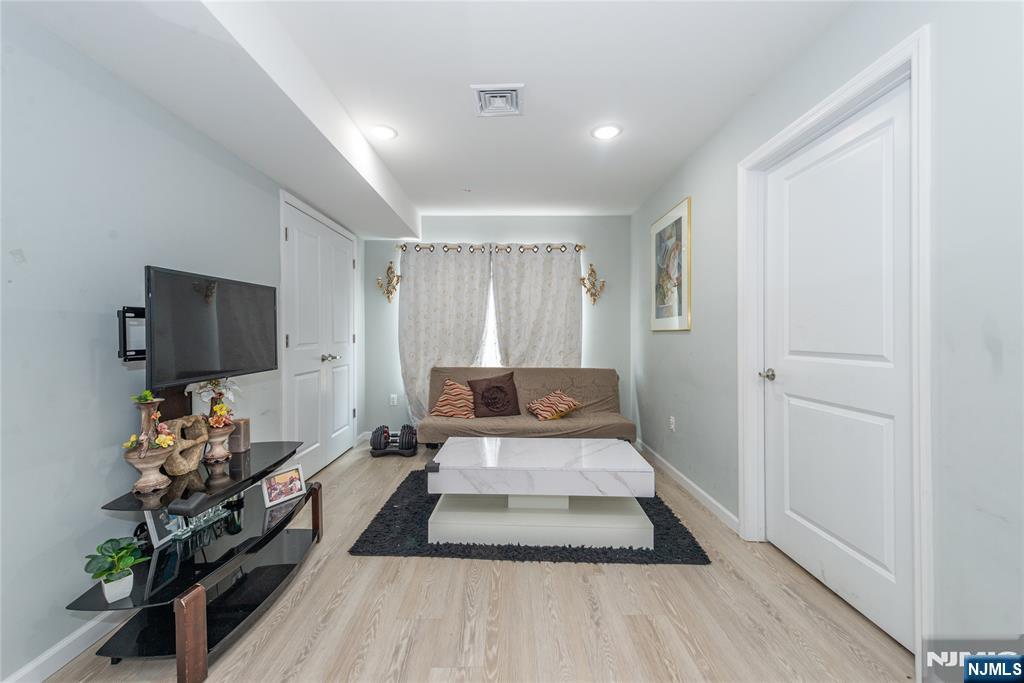 59 Mercer Street Paterson, NJ 07524 - Photo 8 of 15 a living room with furniture and a flat screen tv