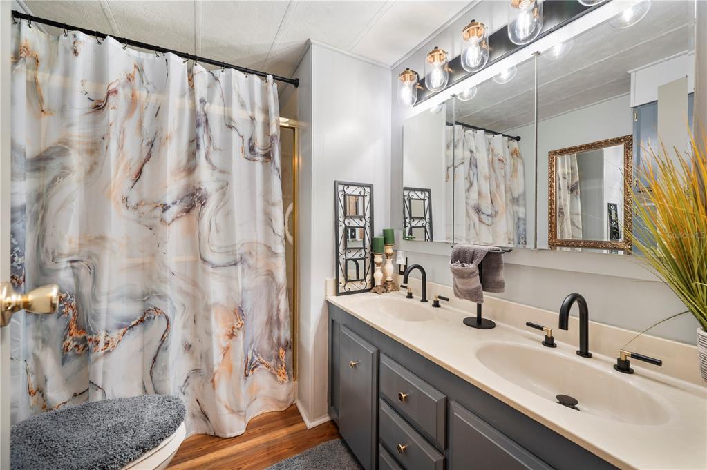 1610 Reynolds Road, Unit 187 Lakeland, FL 33801 - Photo 11 of 20 a bathroom with a double vanity sink and a mirror