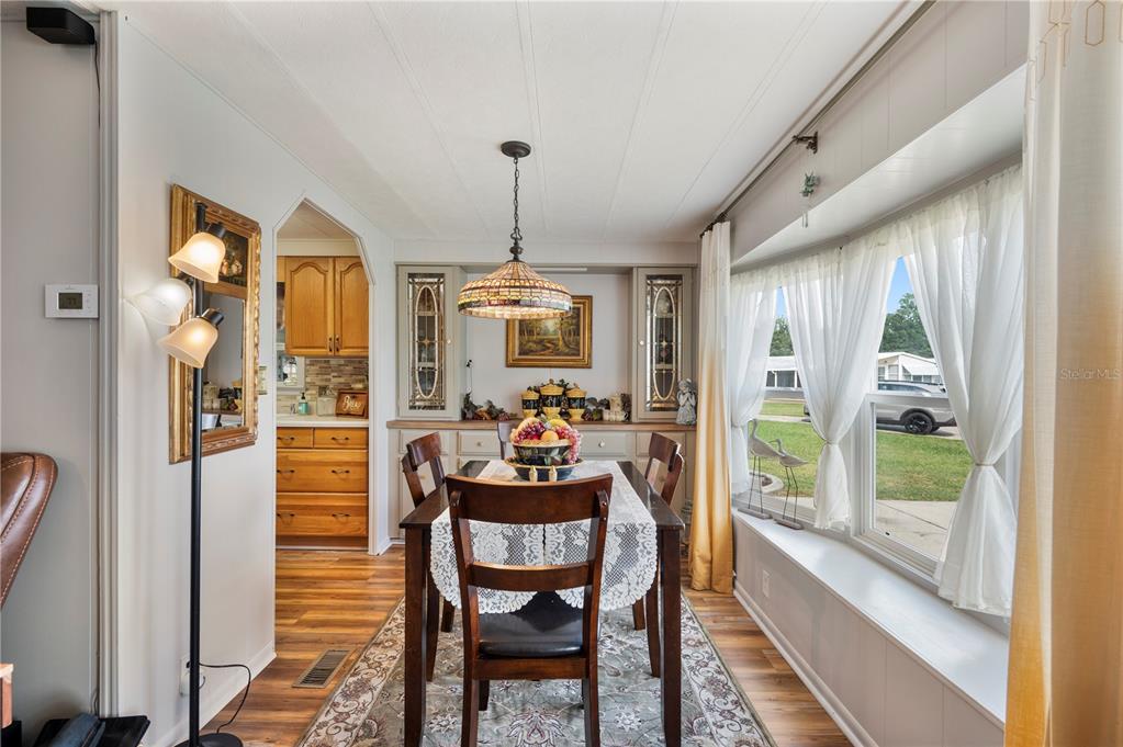 1610 Reynolds Road, Unit 187 Lakeland, FL 33801 - Photo 4 of 20 a dining room with furniture a chandelier and wooden floor