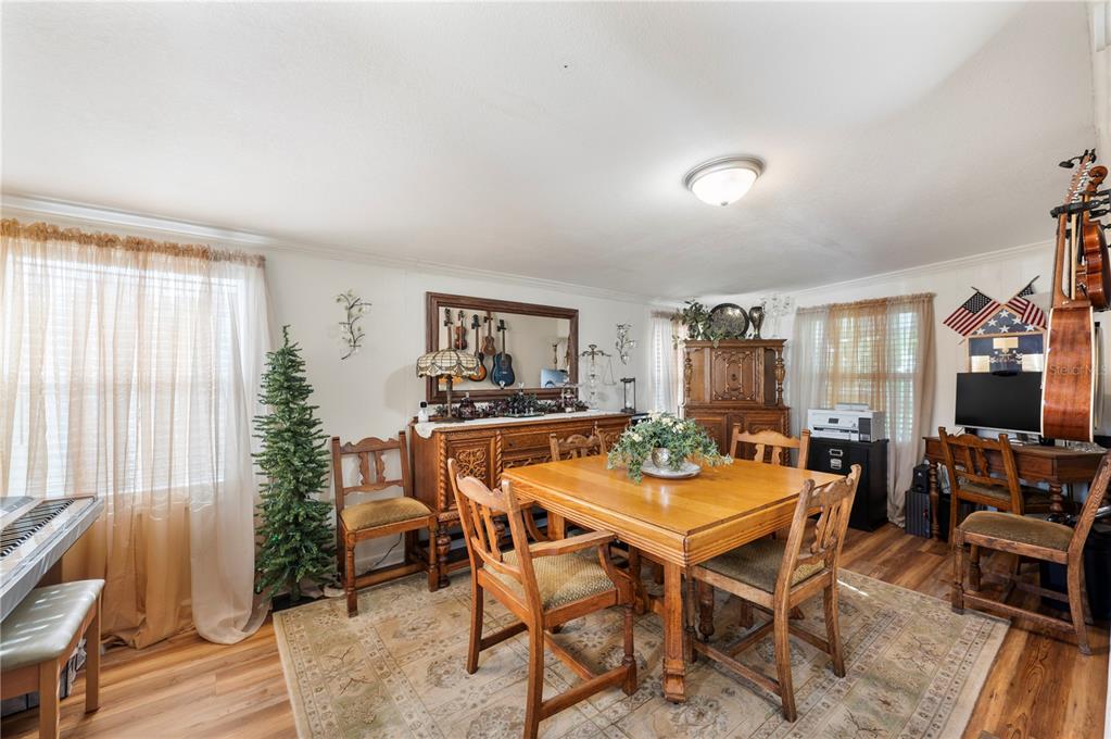 1610 Reynolds Road, Unit 187 Lakeland, FL 33801 - Photo 7 of 20 a view of a dining room with furniture and wooden floor