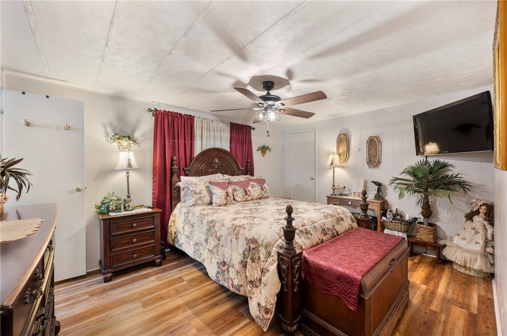 1610 Reynolds Road, Unit 187 Lakeland, FL 33801 - Photo 8 of 20 a bedroom with a bed a flat screen tv and a chandelier