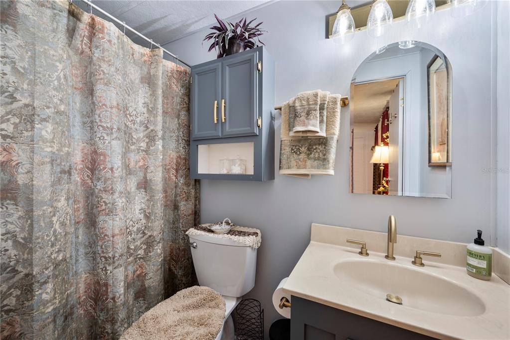 1610 Reynolds Road, Unit 187 Lakeland, FL 33801 - Photo 9 of 20 a bathroom with a toilet sink and mirror