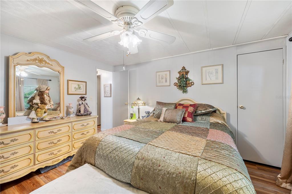 1610 Reynolds Road, Unit 187 Lakeland, FL 33801 - Photo 10 of 20 a bedroom with a large bed and a chandelier