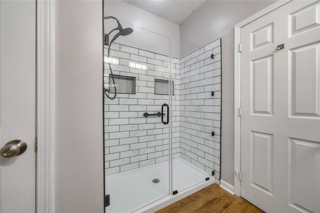 3635 Roseman Landing Cumming, GA 30040 - Photo 15 of 31 a bathroom with a glass shower door