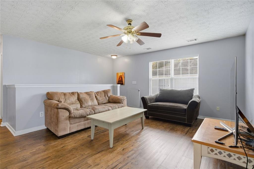 3635 Roseman Landing Cumming, GA 30040 - Photo 16 of 31 a living room with furniture and a window