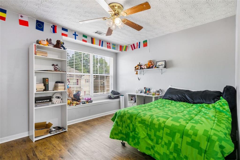 3635 Roseman Landing Cumming, GA 30040 - Photo 17 of 31 a bedroom with furniture and a bed