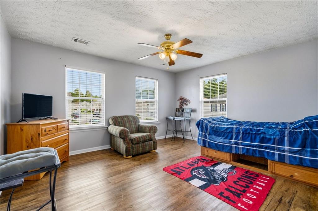 3635 Roseman Landing Cumming, GA 30040 - Photo 18 of 31 a living room with furniture a flat screen tv and a window