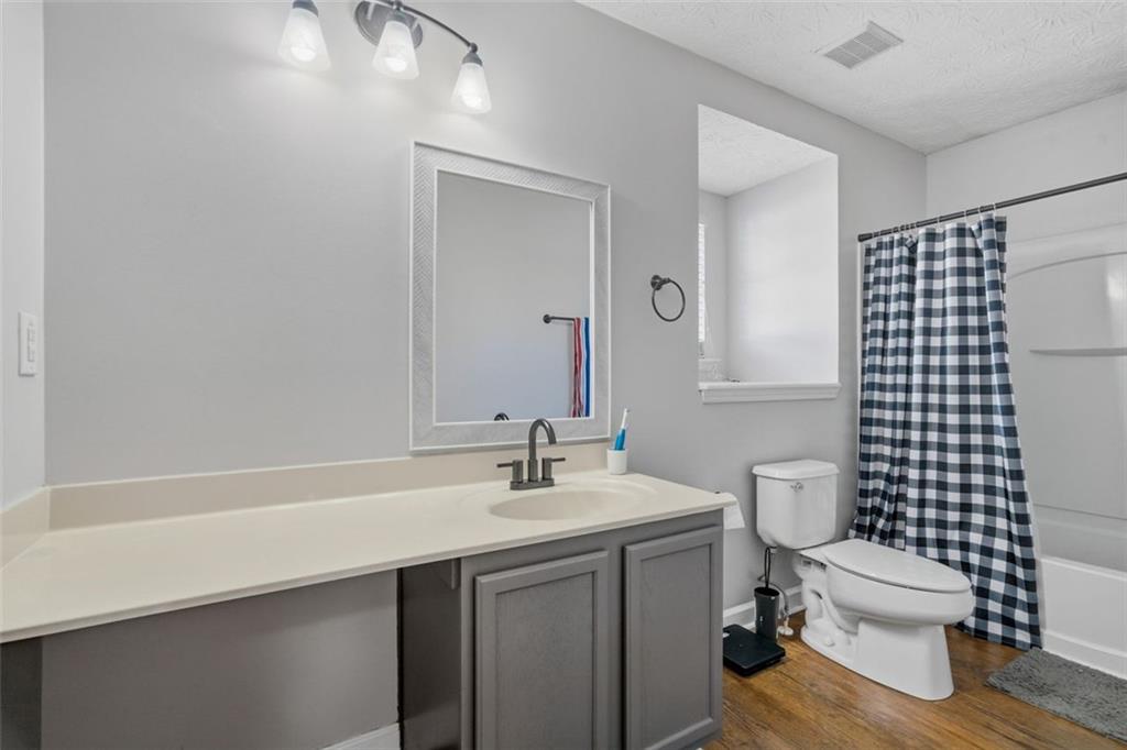 3635 Roseman Landing Cumming, GA 30040 - Photo 19 of 31 a bathroom with a sink toilet and shower