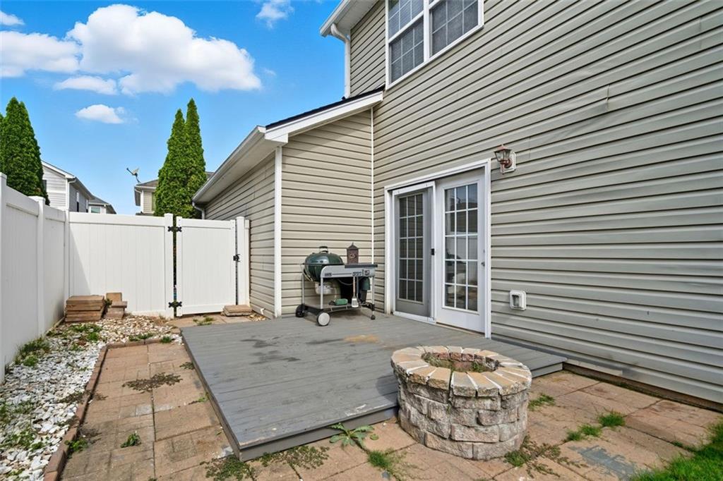 3635 Roseman Landing Cumming, GA 30040 - Photo 22 of 31 a backyard of a house with barbeque oven table and chairs