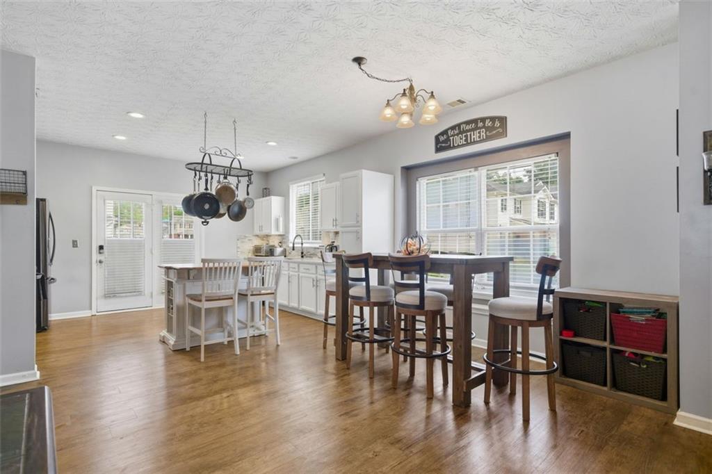 3635 Roseman Landing Cumming, GA 30040 - Photo 3 of 31 a view of a dining room with furniture window and wooden floor