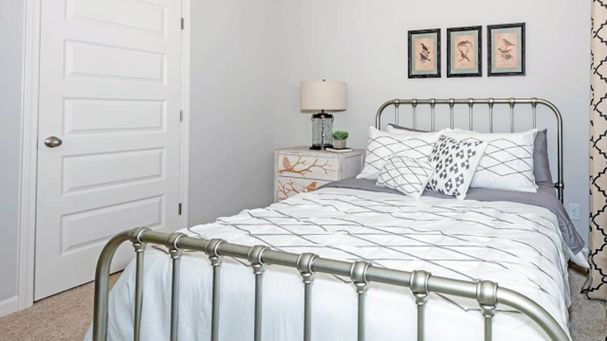 1734 Carter Daniel Drive Graham, NC 27253 - Photo 17 of 23 a bedroom with a bed and a painting on the wall