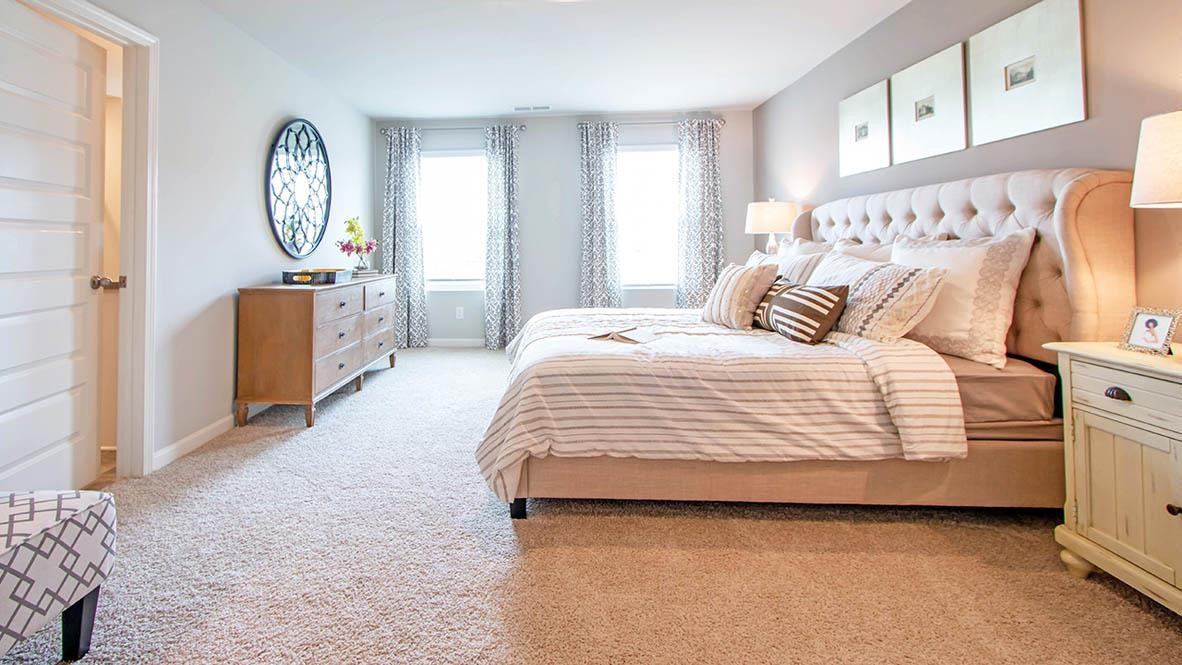 1734 Carter Daniel Drive Graham, NC 27253 - Photo 20 of 23 a bedroom with a bed and a chandelier