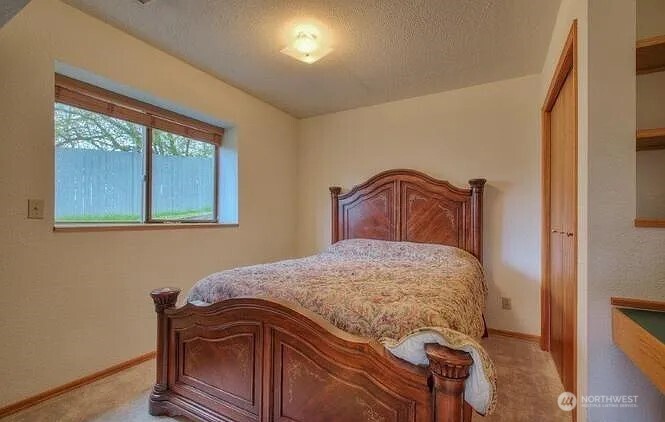 9502 South 200th Street Kent, WA 98031 - Photo 11 of 21 a bedroom with a bed and wooden floor