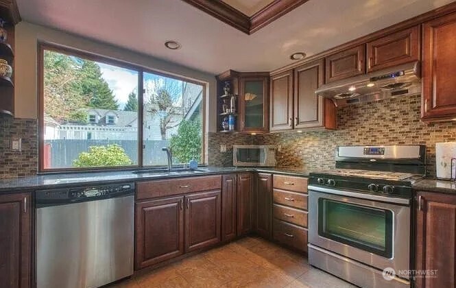 9502 South 200th Street Kent, WA 98031 - Photo 7 of 21 a kitchen with a stove and a sink