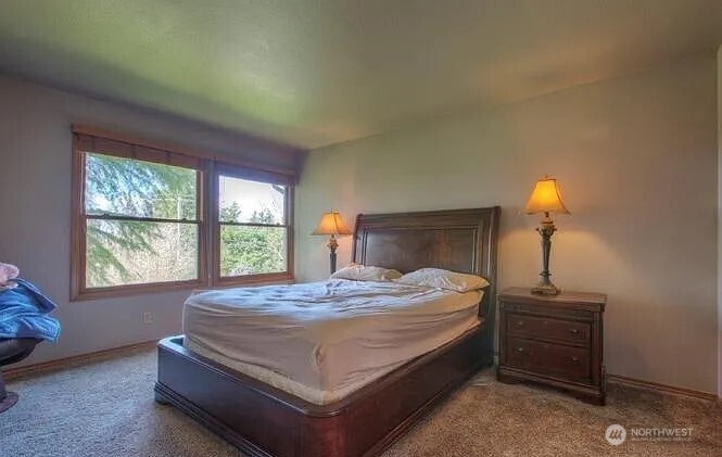 9502 South 200th Street Kent, WA 98031 - Photo 9 of 21 a bed sitting in a bedroom next to a window