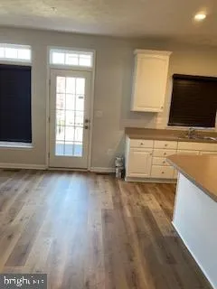 a kitchen with wooden floors and sink