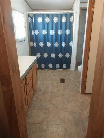 a view of wooden floor and windows in a room