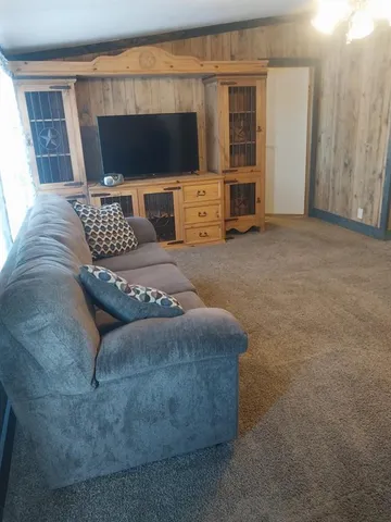 a bedroom with a bed and flat screen tv